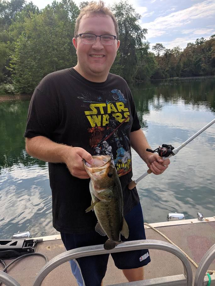 Bill smiling with fish on pond